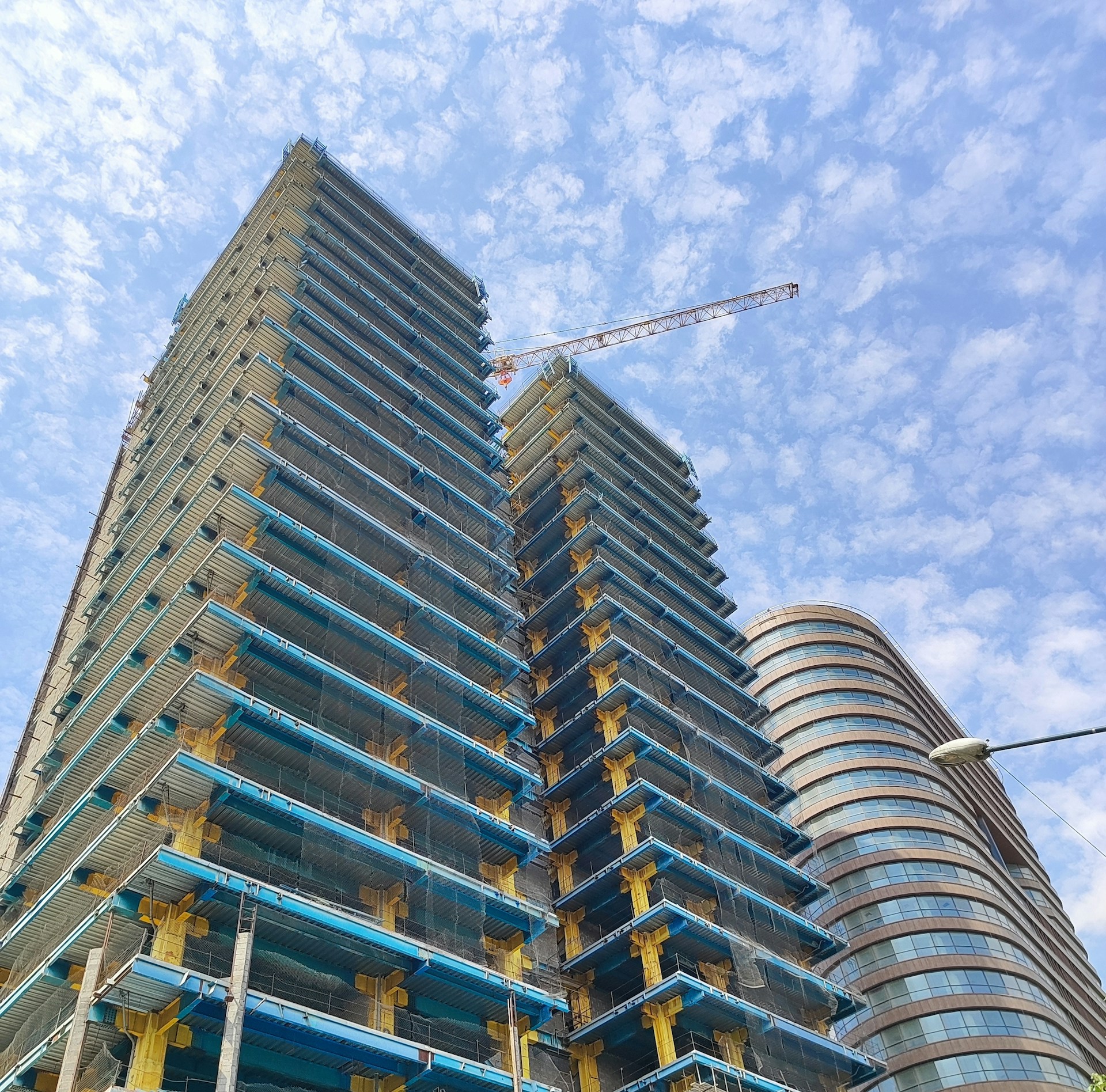 woman wearing yellow long-sleeved dress under white clouds and blue sky during daytime