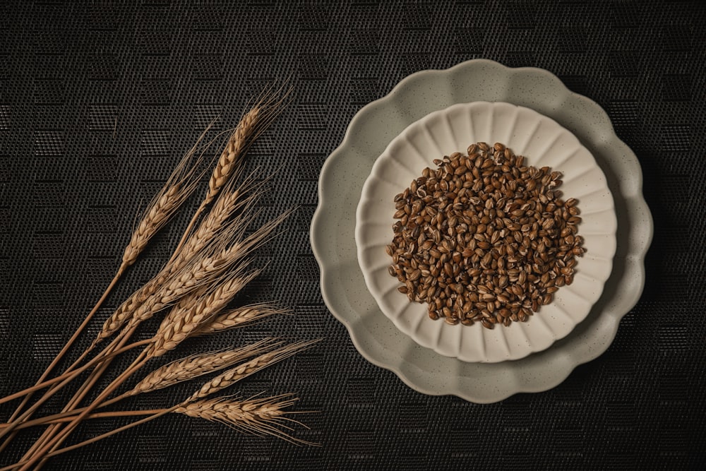 a white plate topped with a pile of brown grains