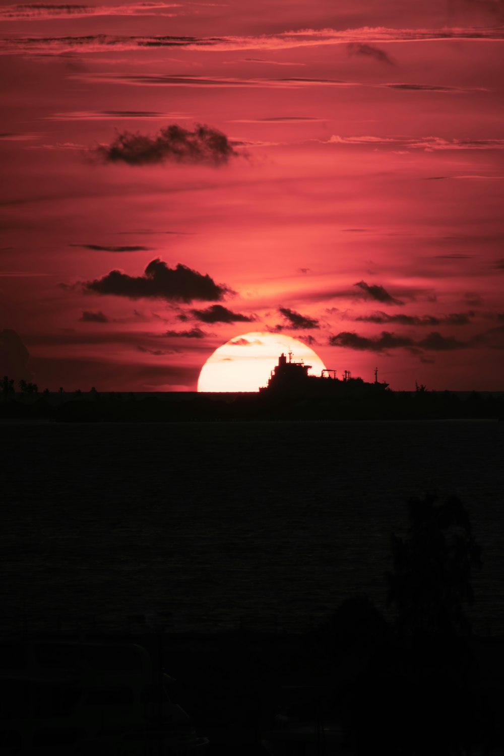 the sun is setting over a large body of water