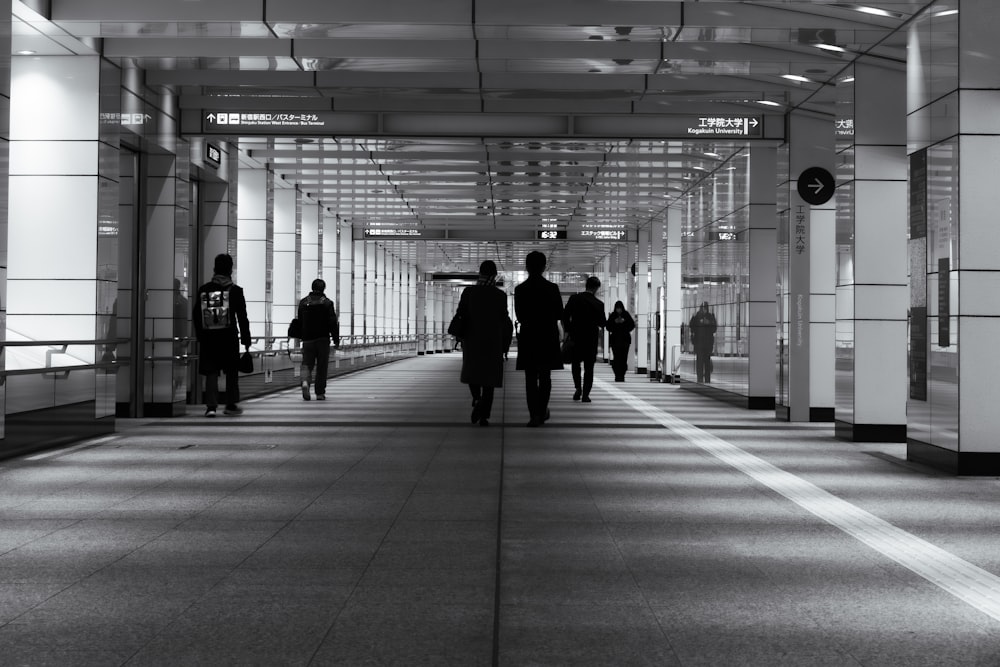 a group of people walking down a hallway