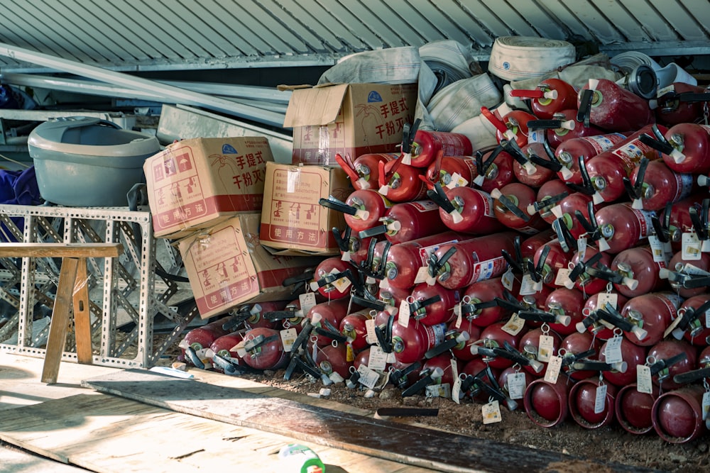 a pile of red fire hydrants sitting next to each other
