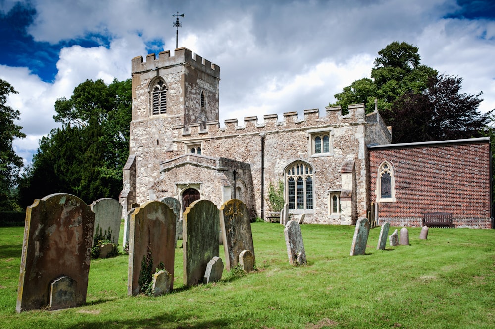 a church with a tower and a graveyard in front of it