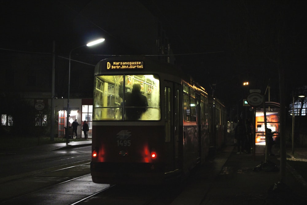 a public transit bus on a city street at night