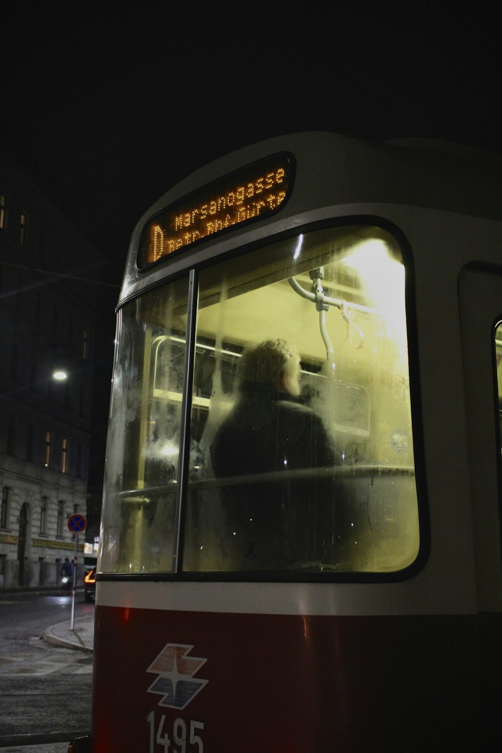 a person sitting in a bus at night
