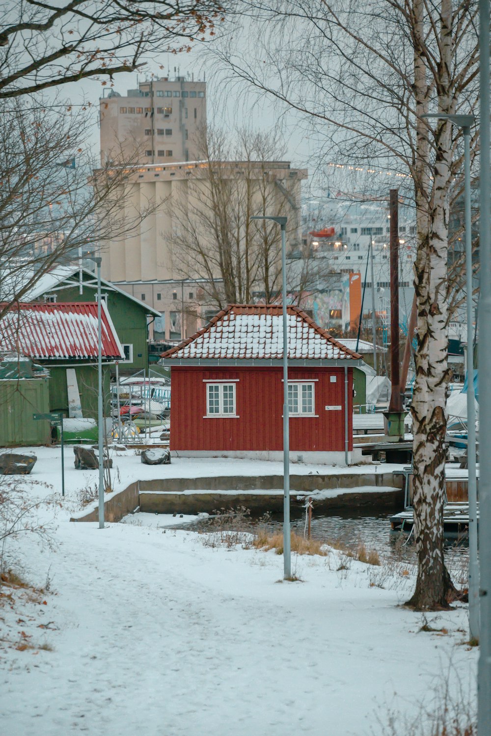 a small red house in the middle of a snowy area