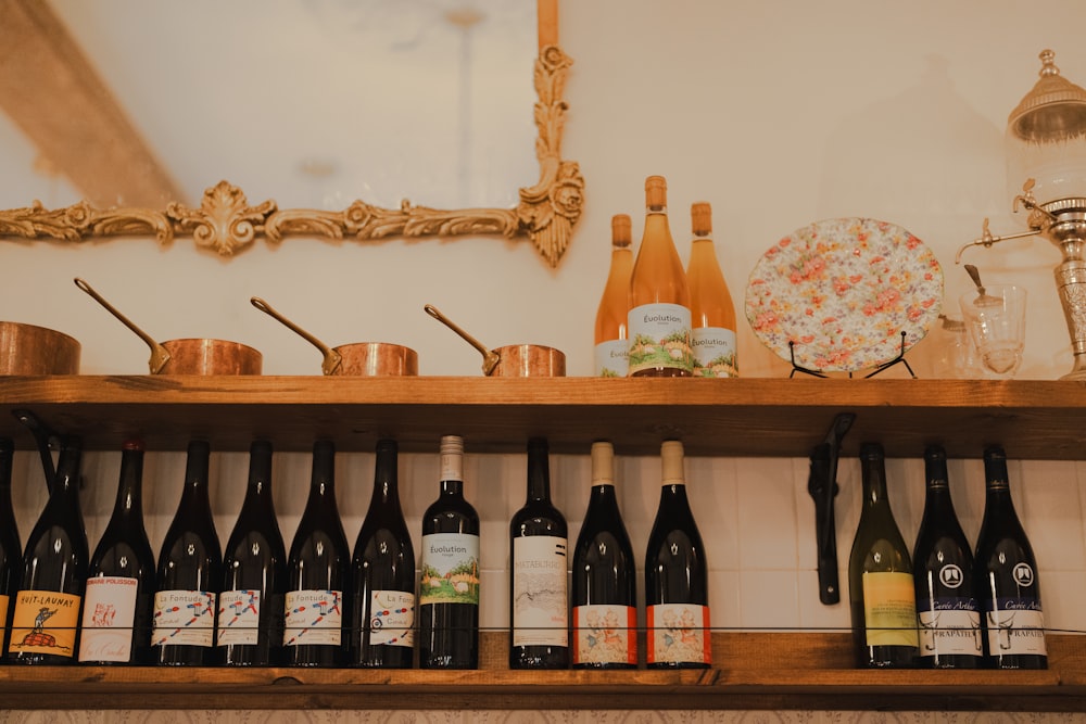 a wooden shelf filled with lots of bottles of wine
