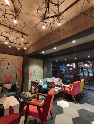 Cozy and welcoming common area of Georgeshousesmani with warm lighting and comfortable seating.