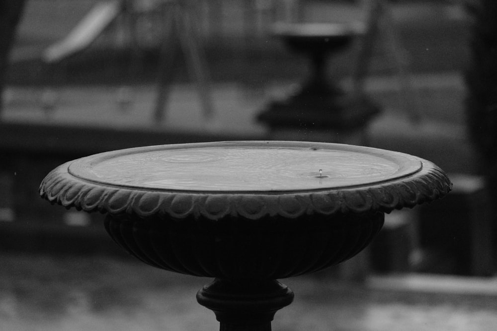 a black and white photo of a bird bath