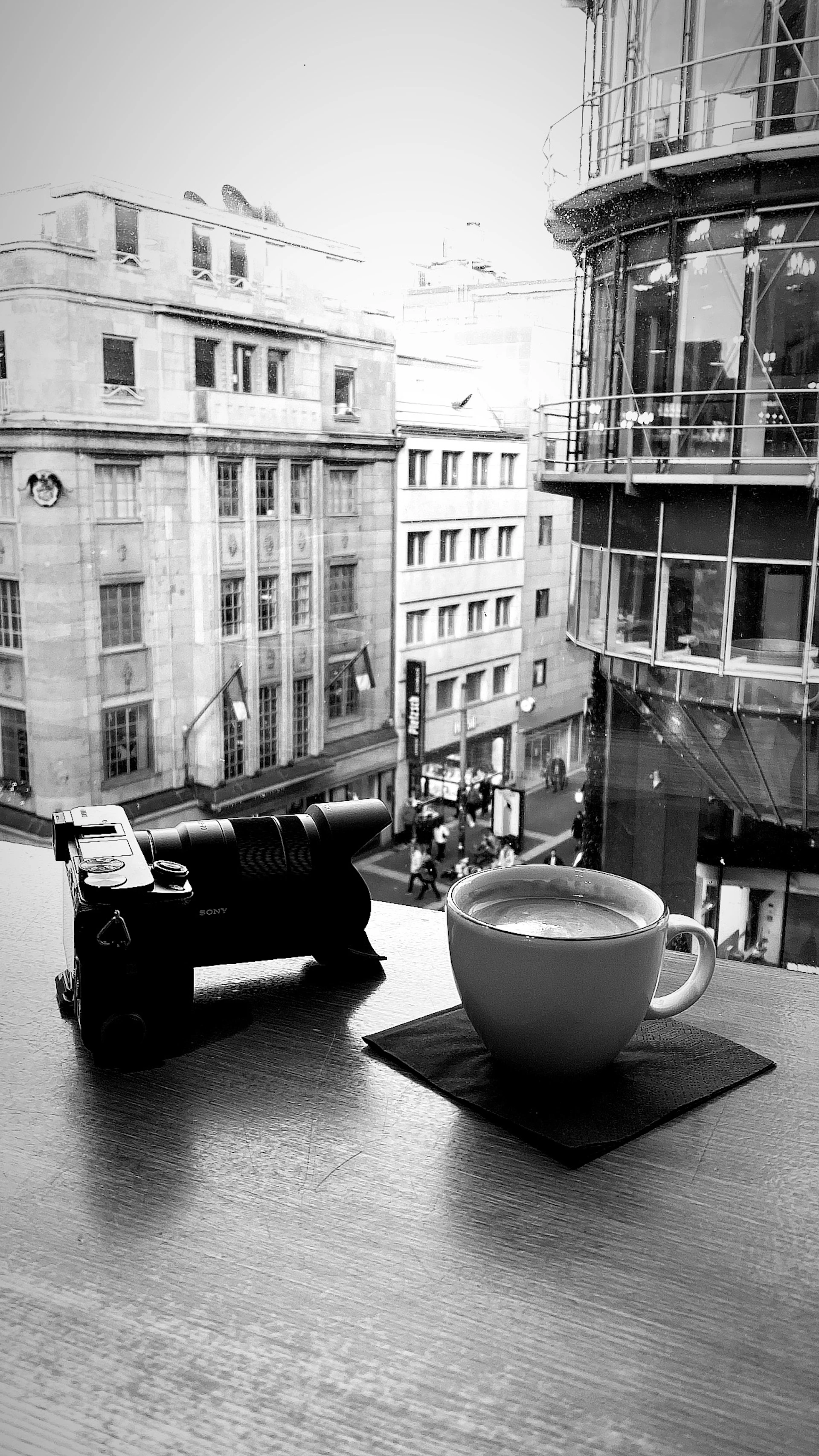 A delicate black-and-white photograph showcasing a quiet moment of urban life, reflecting Deborah's eye for subtle storytelling.
