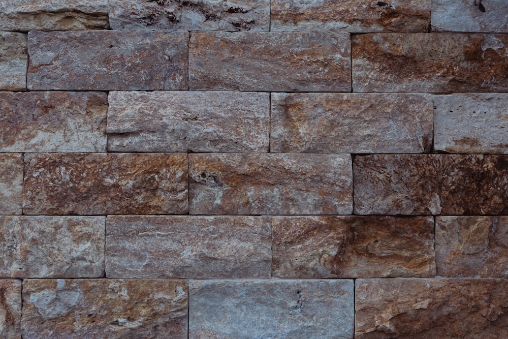 a close up of a wall made of stone blocks