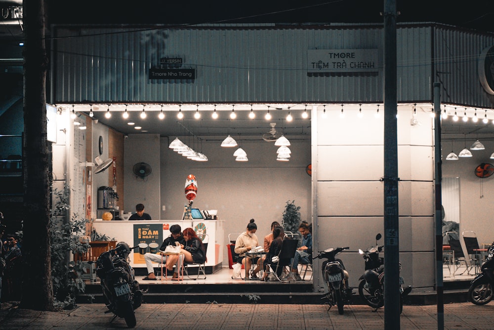 a group of people sitting outside of a building