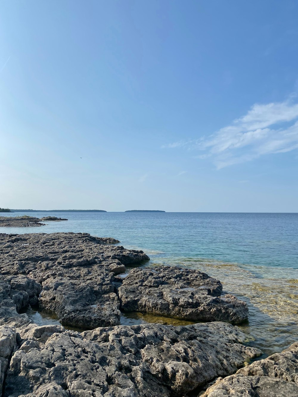 a view of the ocean from a rocky shore