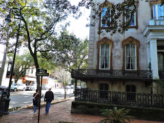 A friendly portrait of Gordon standing in front of a charming Savannah neighborhood.