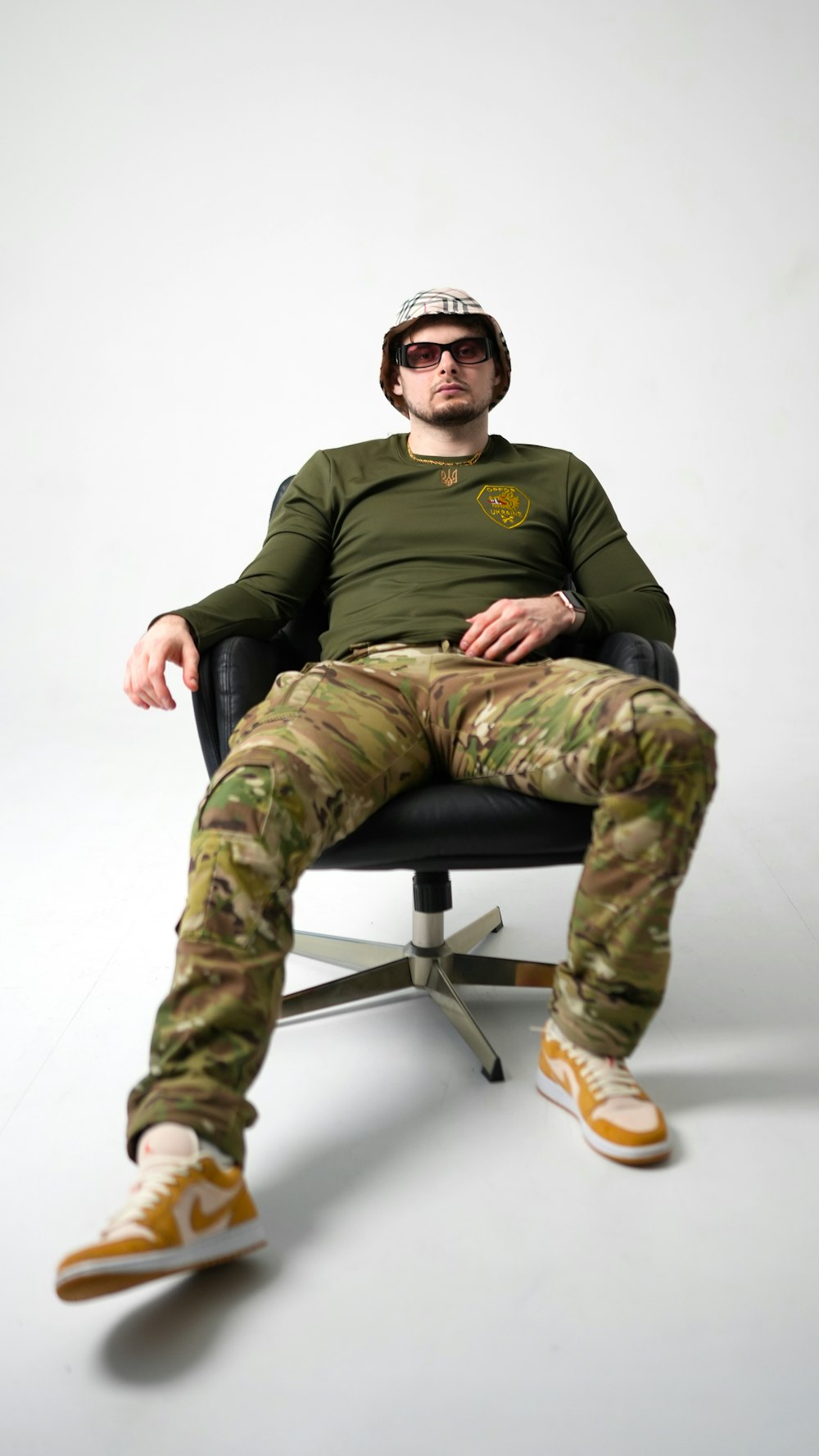 a man sitting in a chair with his legs crossed