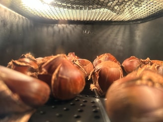 A warm, inviting kitchen scene with hazelnuts being roasted over an open flame.