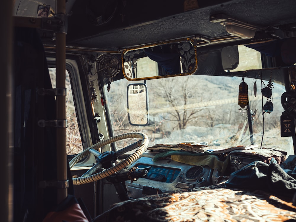 the inside of a vehicle with a lot of junk on the floor