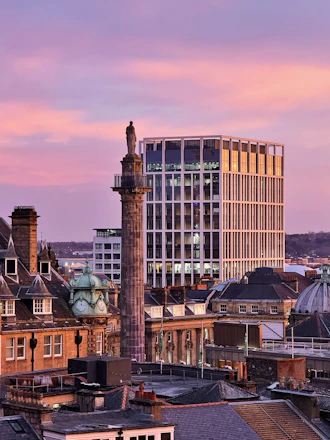 a view of a city with tall buildings and a clock tower