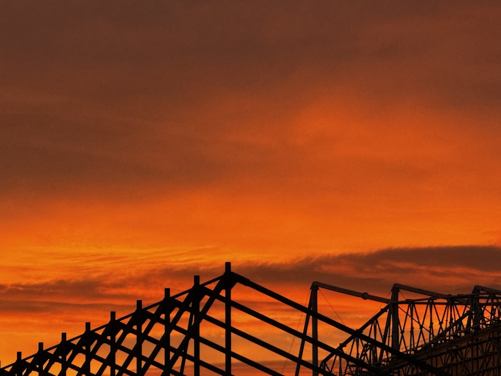 a plane is flying in the sky at sunset