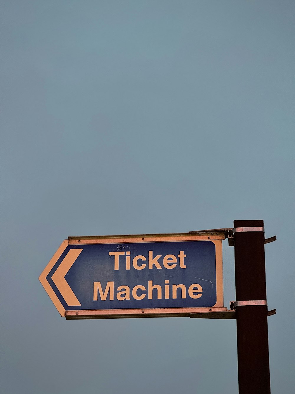 a blue and white sign that says ticket machine