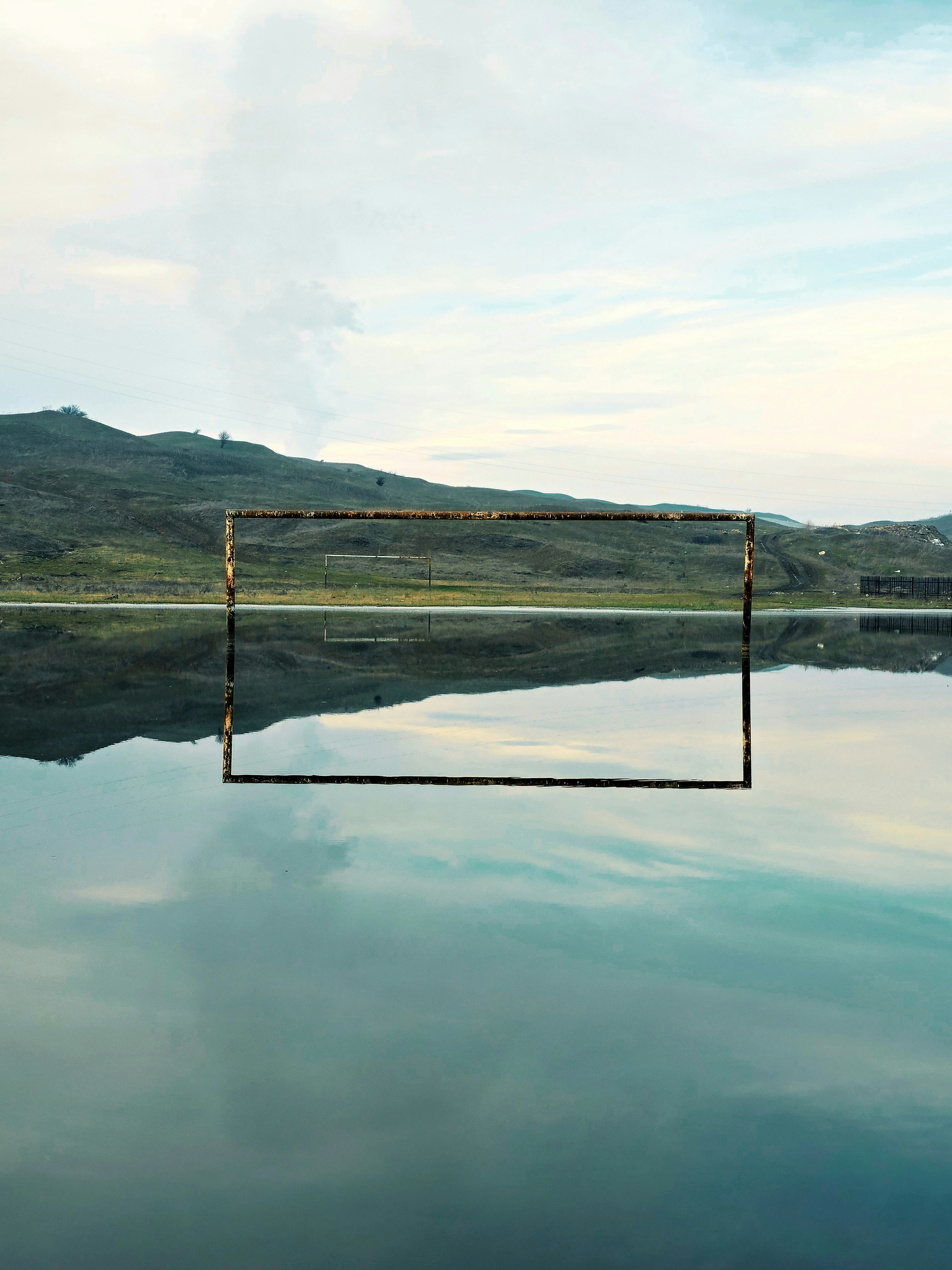 a large body of water with a wooden structure in the middle of it