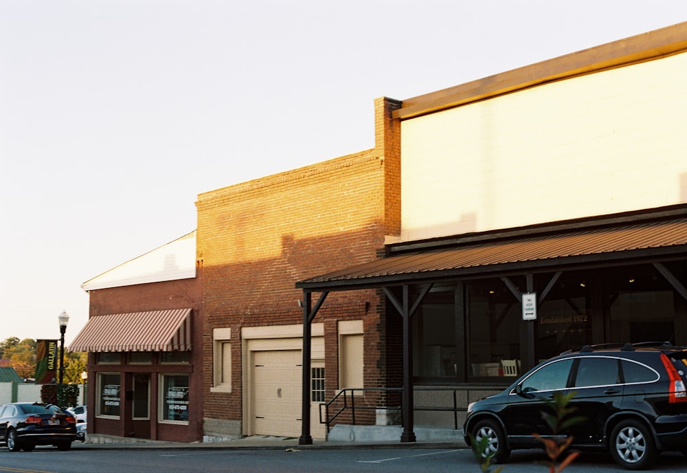 a car parked on the side of a road next to a building