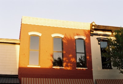 Before and after shots of a commercial property with new windows and refreshed exterior.