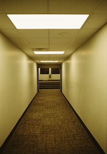 a long hallway with a clock on the wall