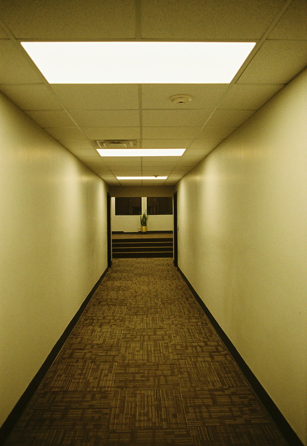 a long hallway with a clock on the wall