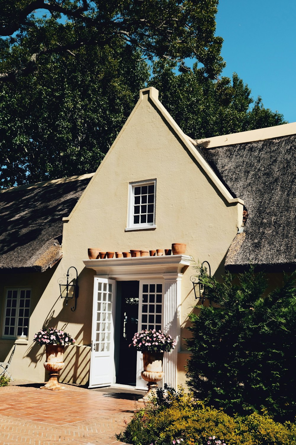 a house with a thatched roof and a white door