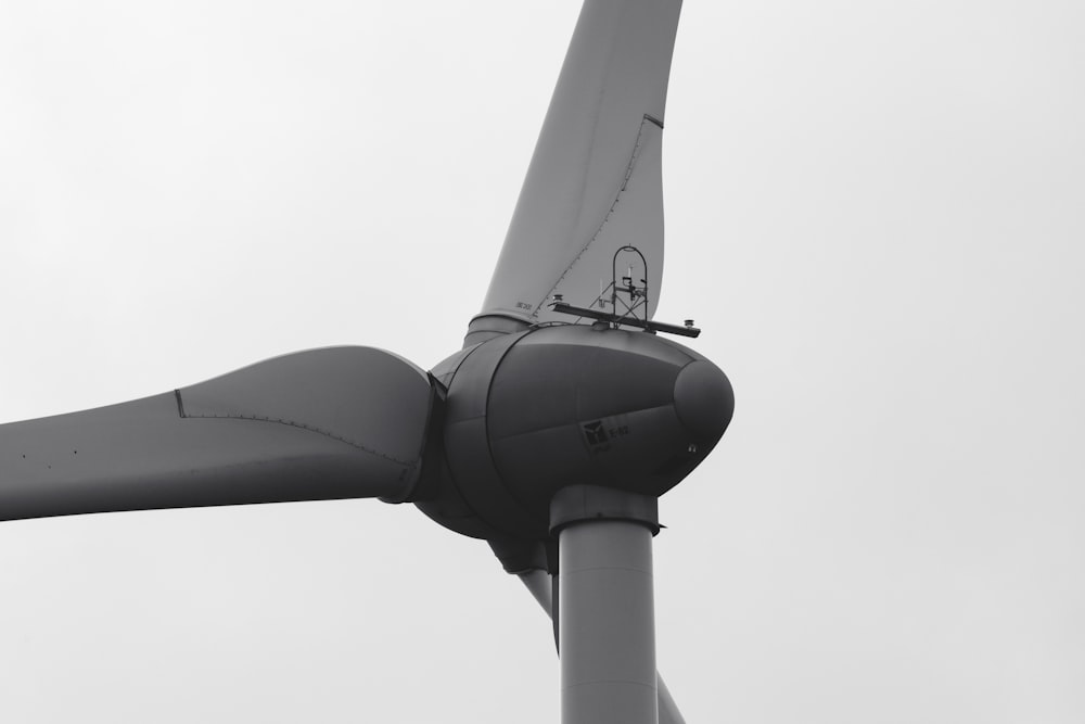 a close up of a wind turbine on a cloudy day