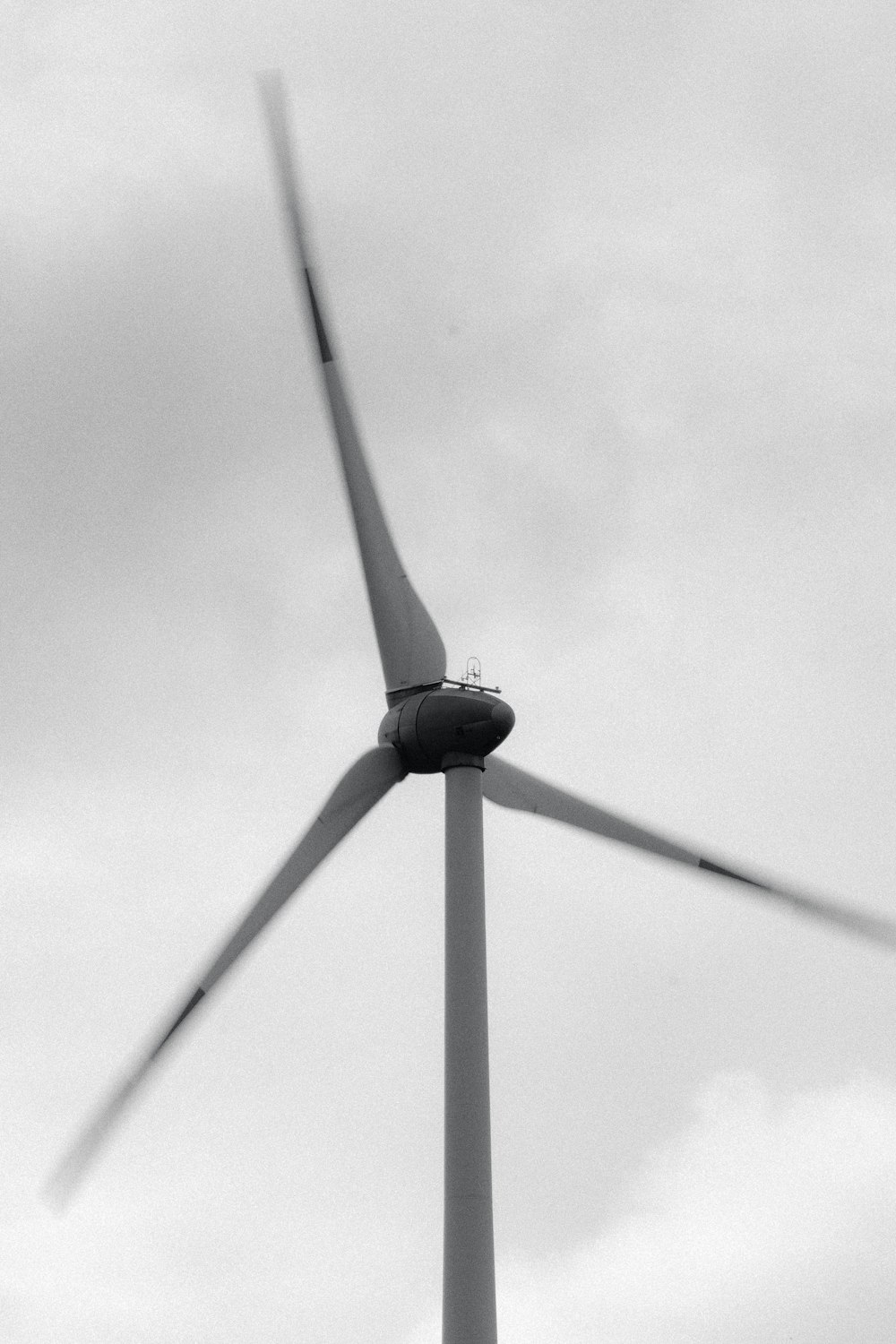 a black and white photo of a wind turbine