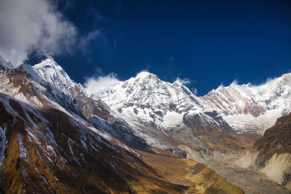 a view of a mountain range with snow on it