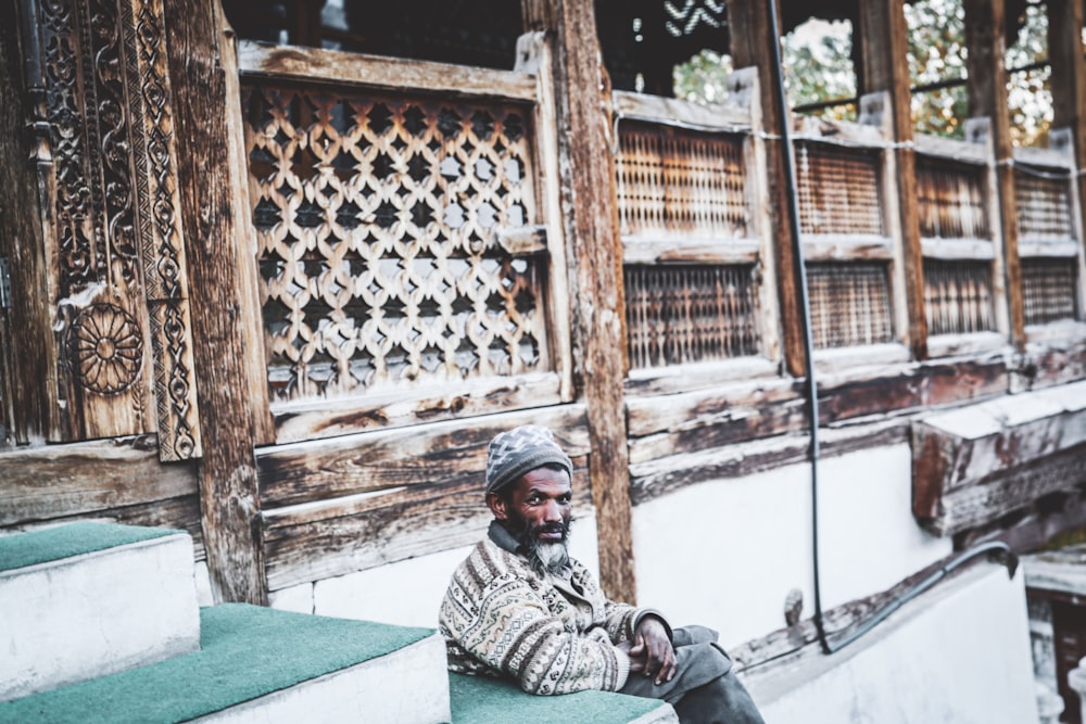 a man sitting on the steps of a building