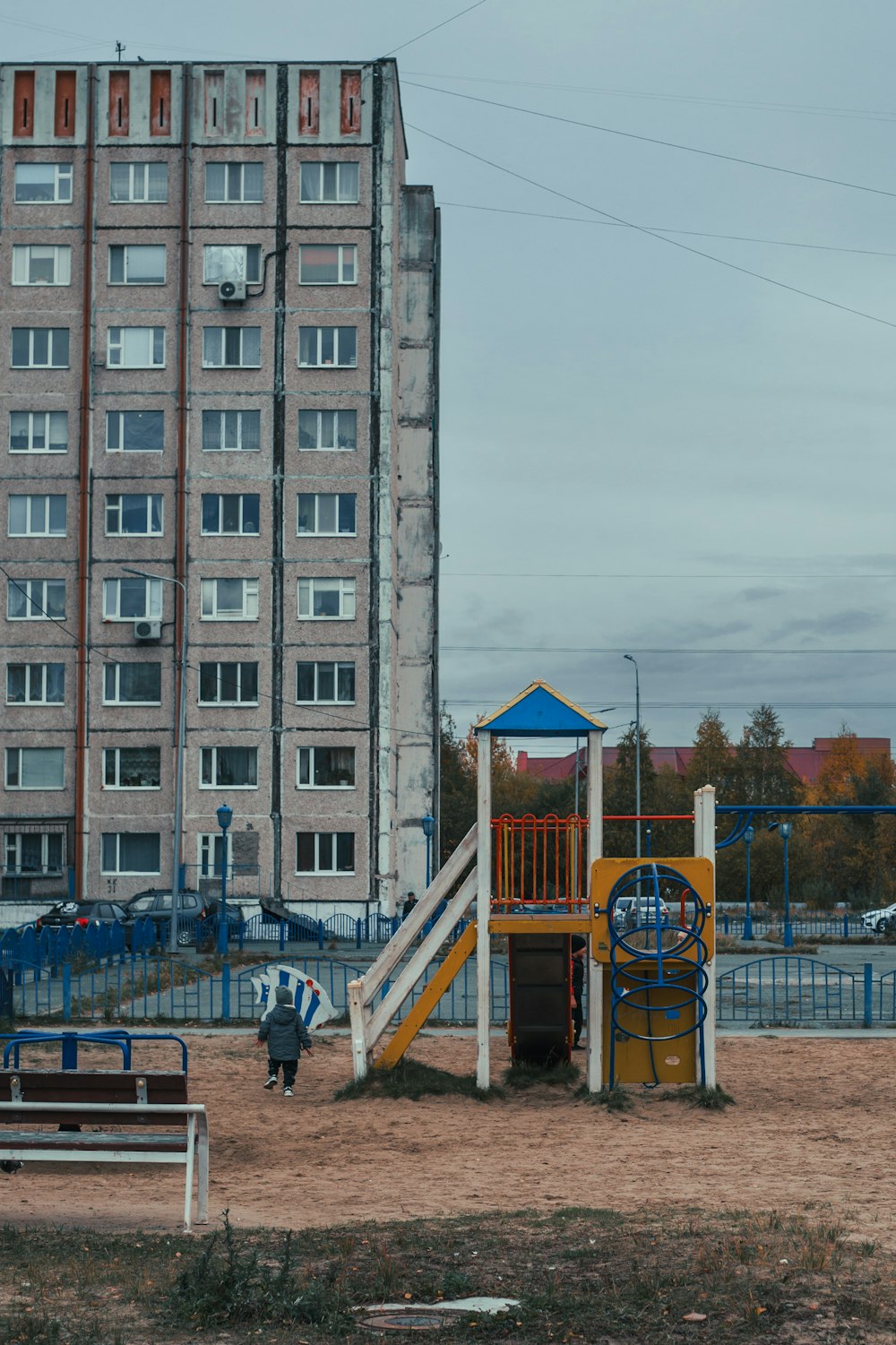 a playground in front of a tall building