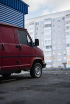 Mobile service van parked outside an office building with technician preparing tools.