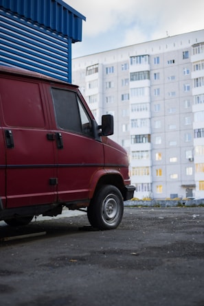 Vision Home Appliances service van parked outside a Dubai Silicon Oasis building.