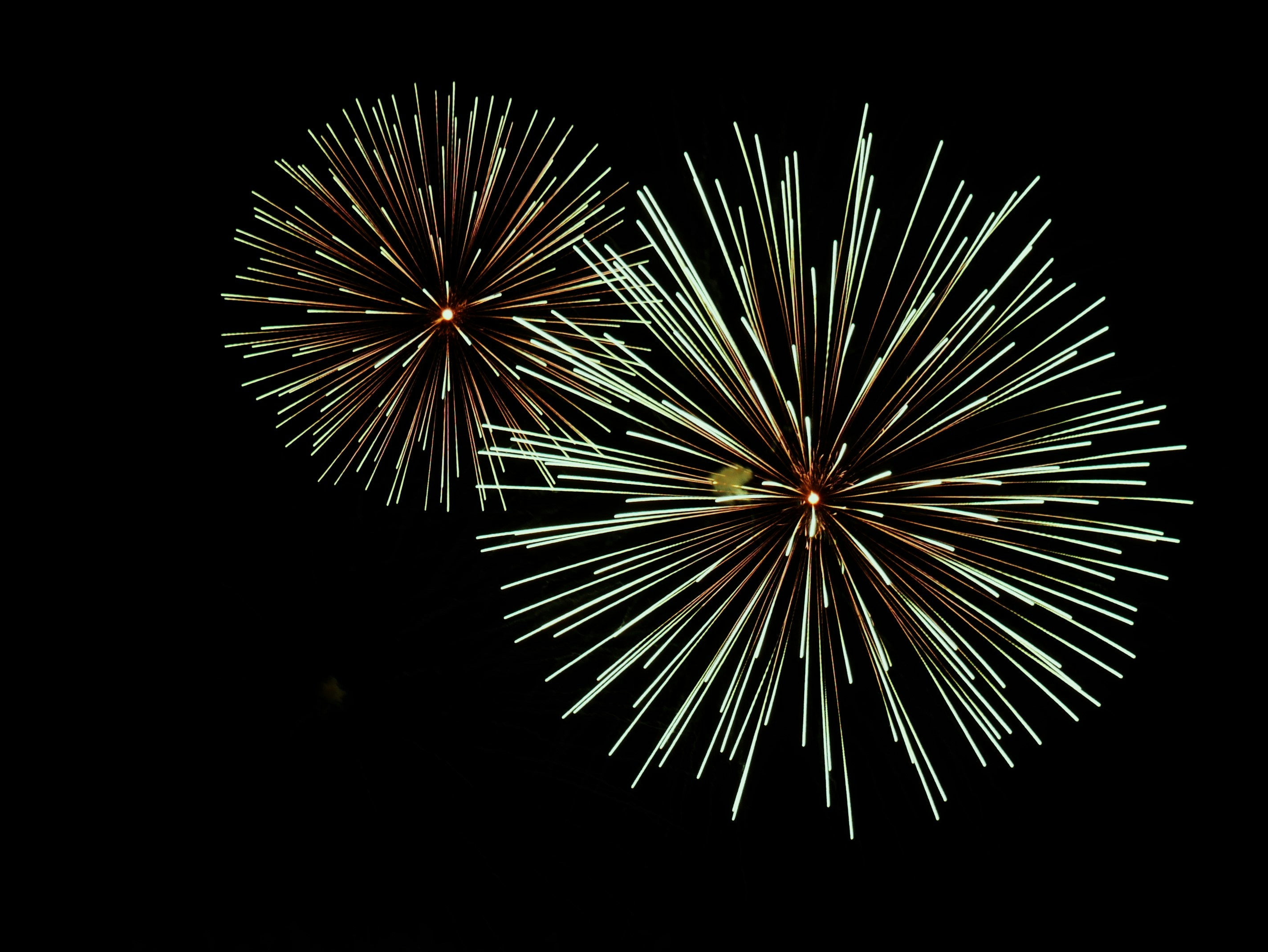 a couple of fireworks that are in the sky
