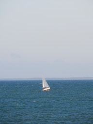 a sailboat in the middle of the ocean