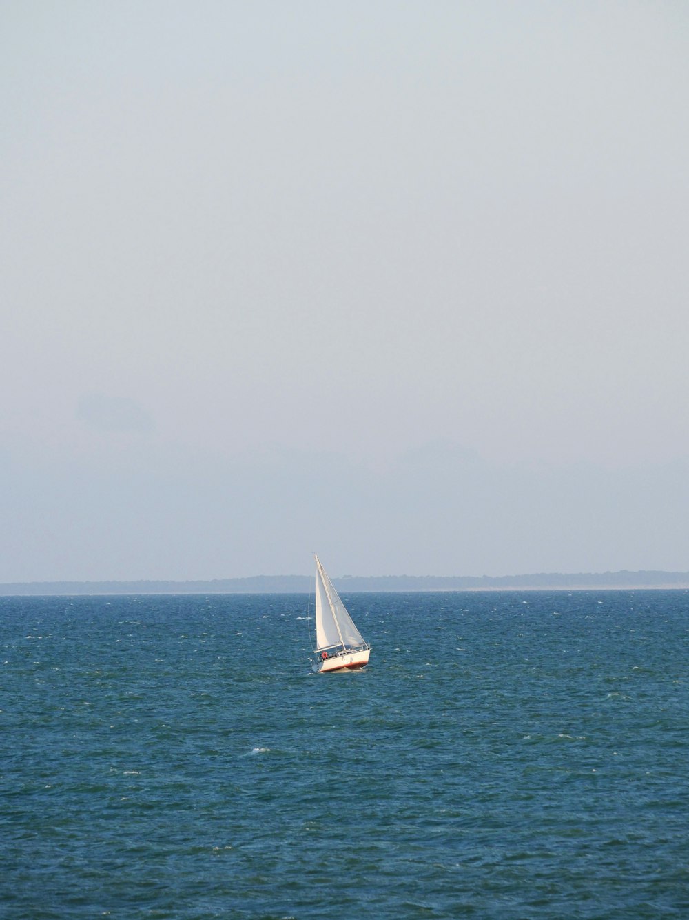 a sailboat in the middle of the ocean