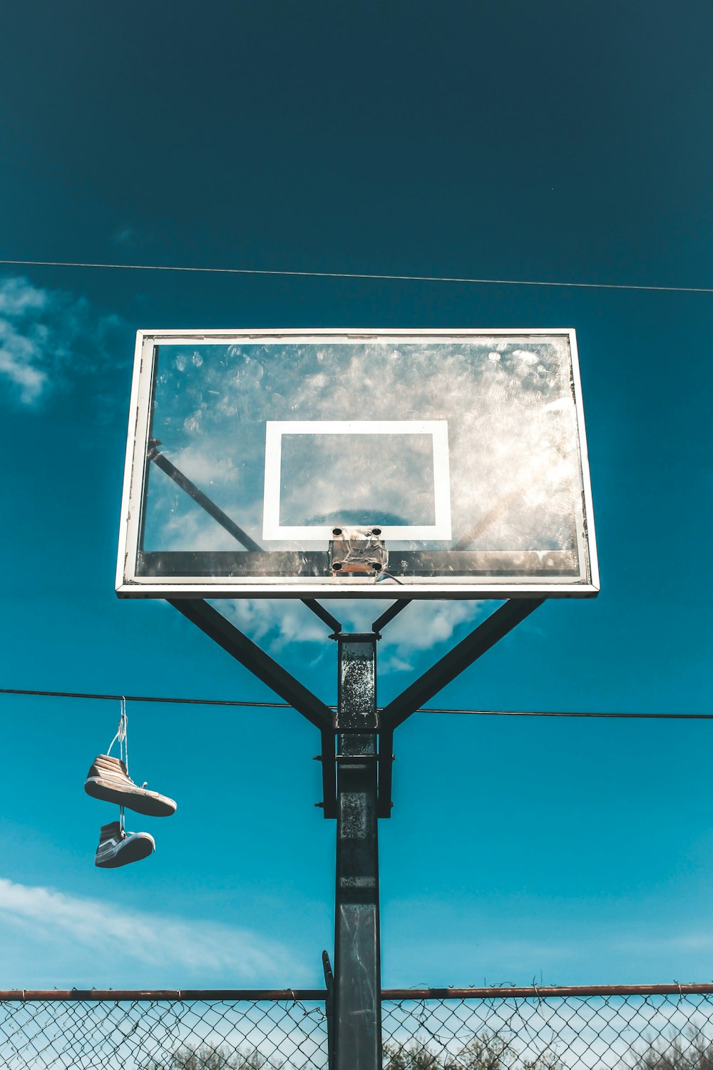 a basketball hoop with a pair of shoes hanging from it