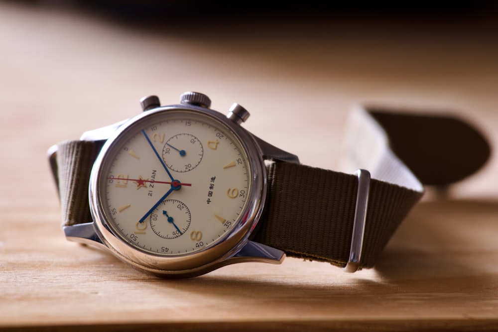 a watch sitting on top of a wooden table