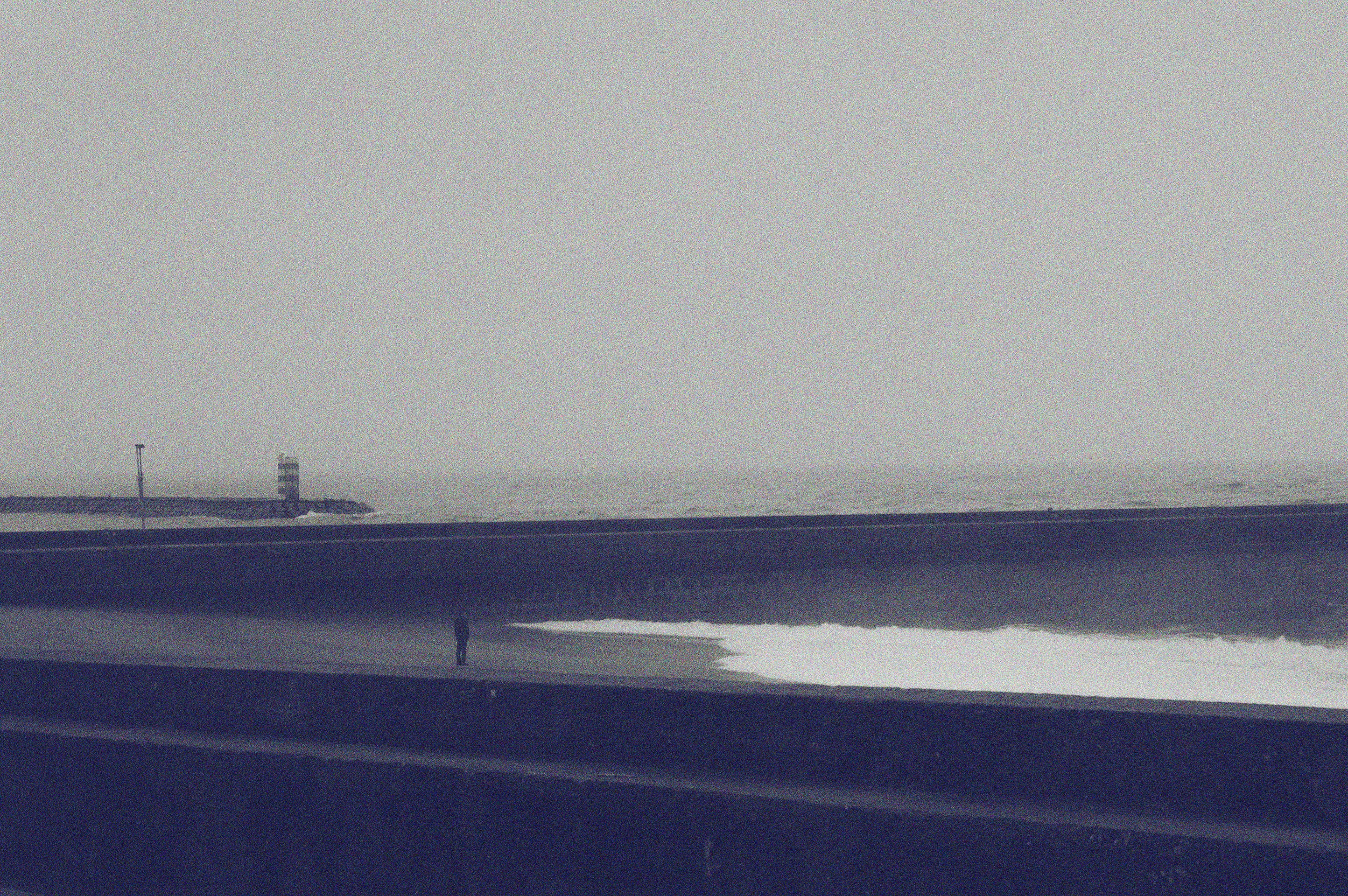a person standing on a beach next to the ocean