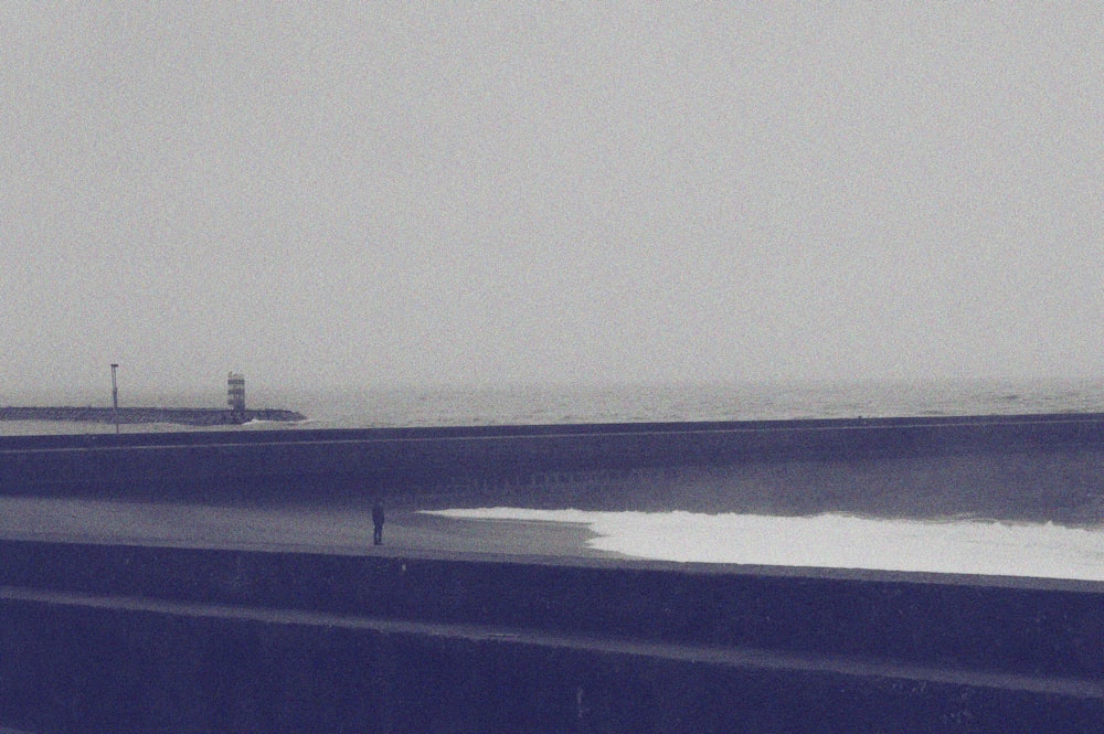 a person standing on a beach next to the ocean