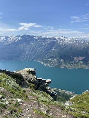 The striking blue hues of Peyto Lake seen from a high vantage point with rocky cliffs.