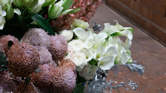 Elegant arrangement of white calla lilies with delicate gypsophila accents