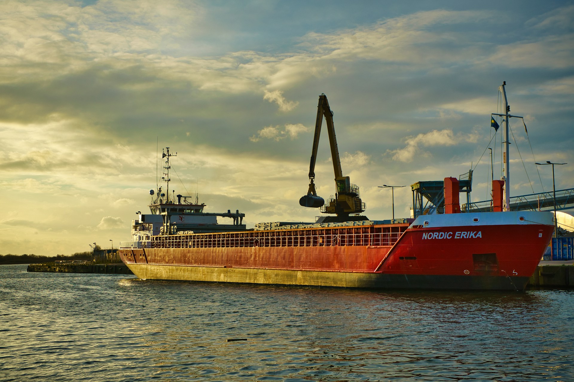 a large red boat floating on top of a body of water