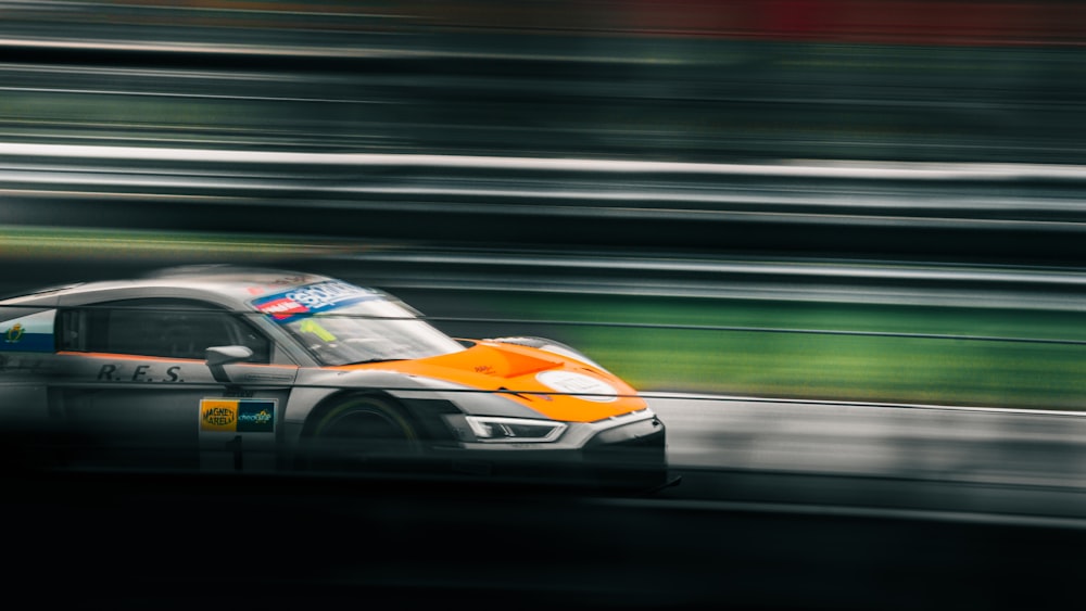 a car driving on a race track with blurry background