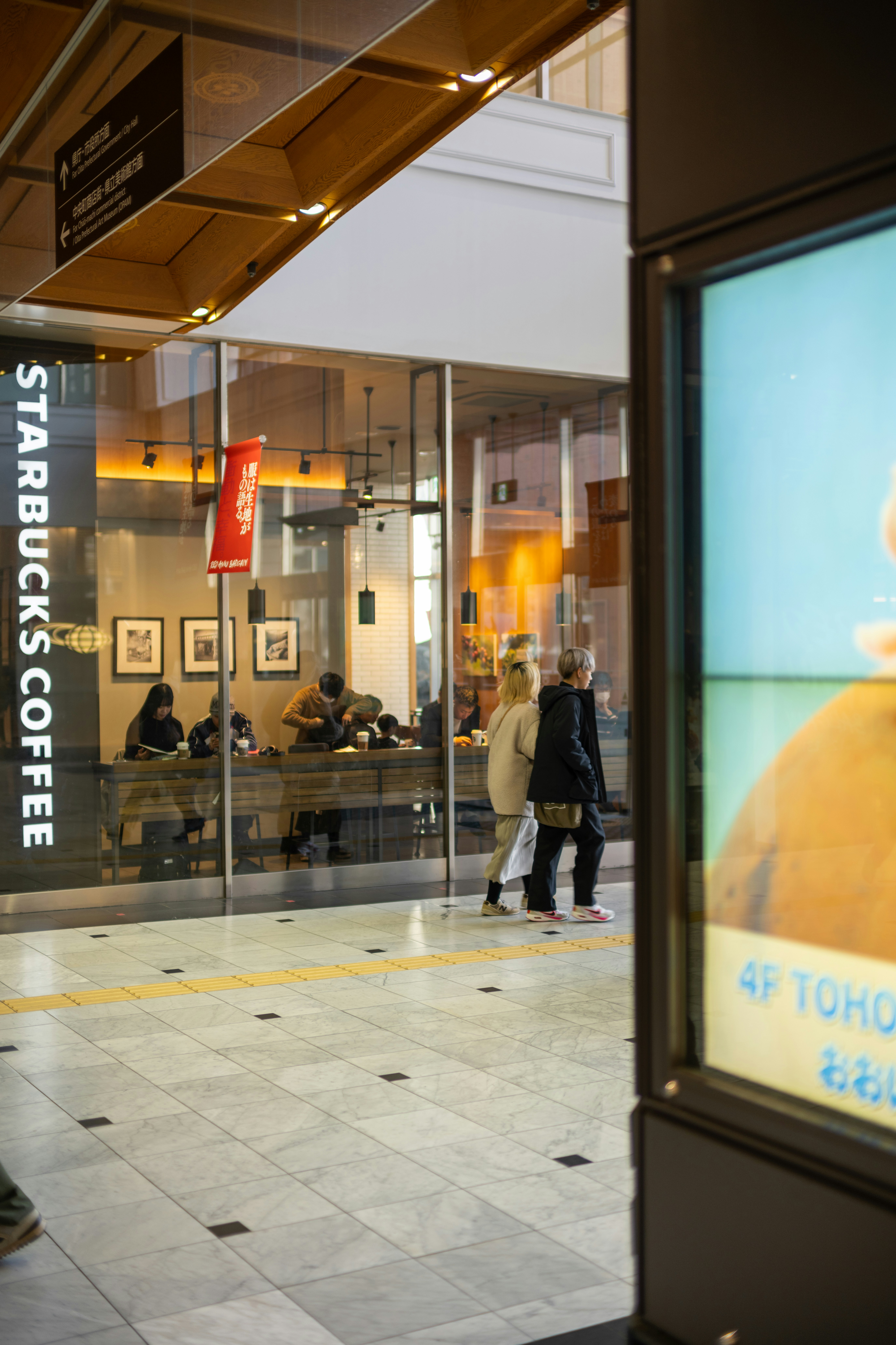 A store front with people walking in front of it photo – Free Woman ...