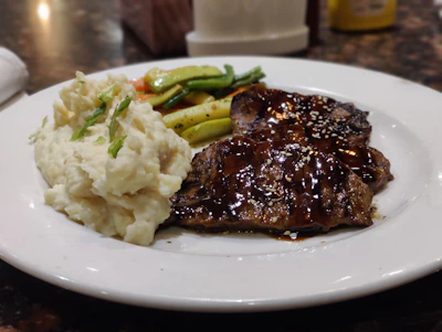 A colorful spread of garnishes including creamy mashed potatoes and sautéed vegetables.