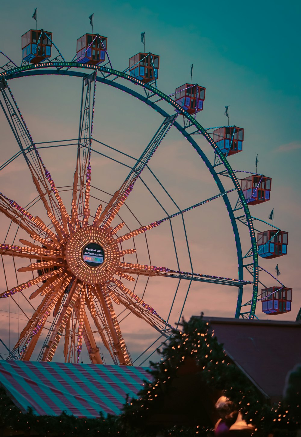 a ferris wheel is lit up at night